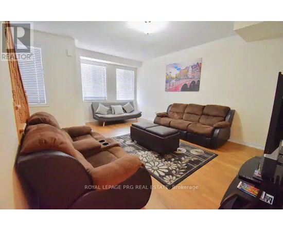 A living room with a brown couch and a television.