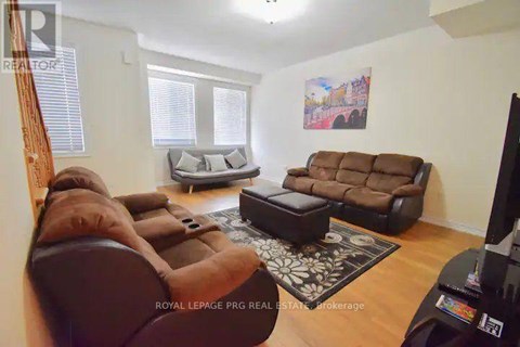 A living room with a brown couch and a television.