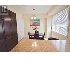 A dining room with a table set for four.