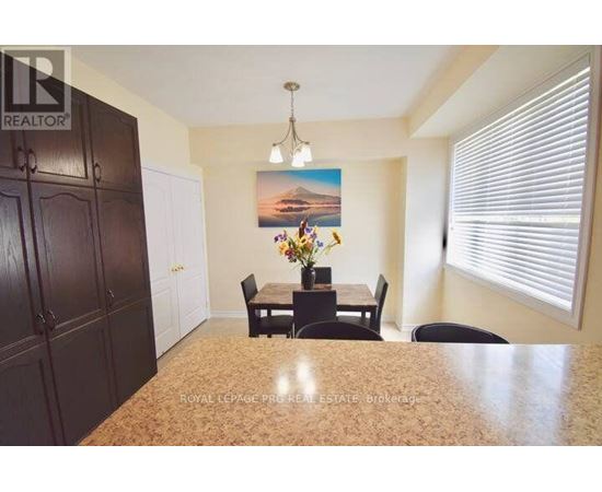 A dining room with a table set for four.