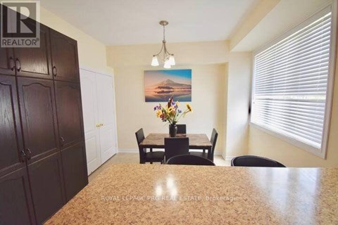 A dining room with a table set for four.