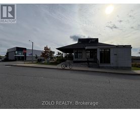 A street view of a building with the text "ZOLO REALTY, Brokerage" on the bottom.