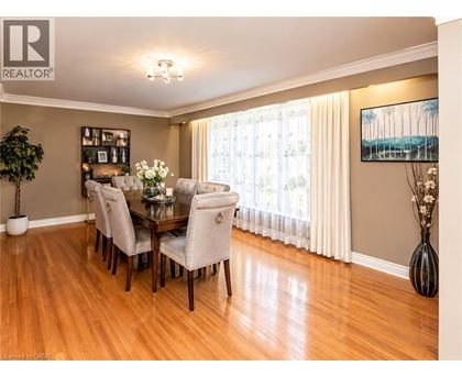 A dining room with a table set for six.