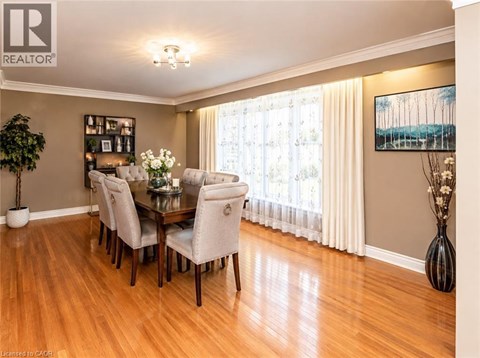 A dining room with a table set for six.