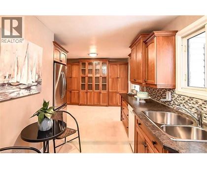 A kitchen with wooden cabinets and a black table.
