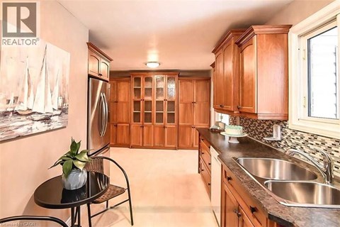 A kitchen with wooden cabinets and a black table.