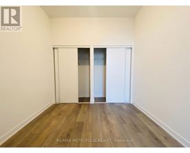 A room with a sliding door and wooden flooring.
