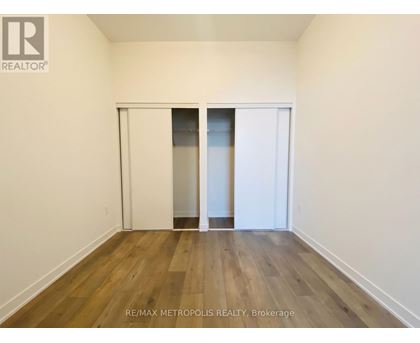 A room with a sliding door and wooden flooring.