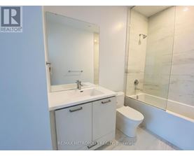 A white bathroom with a sink, toilet and bathtub.