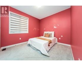 A bedroom with a bed and a window with blinds.