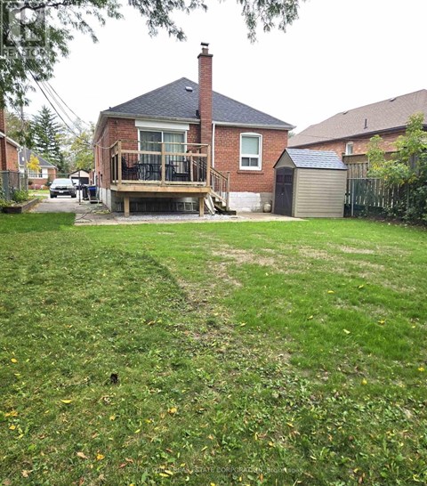 A house with a deck and a garage.