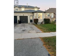 A house with a black garage door is for sale.