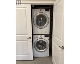 Two washing machines in a small laundry room.