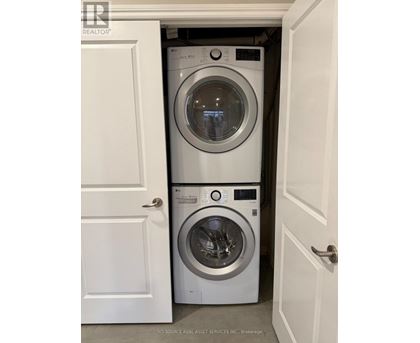 Two washing machines in a small laundry room.