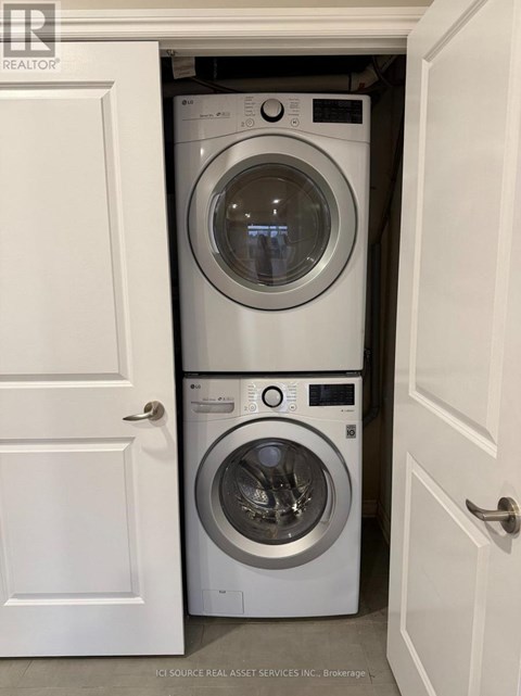 Two washing machines in a small laundry room.