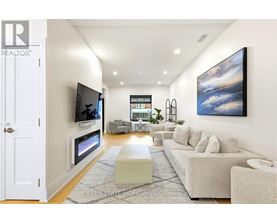A modern living room with a flat screen TV mounted on the wall.