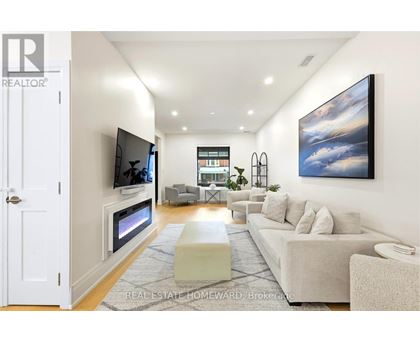 A modern living room with a flat screen TV mounted on the wall.
