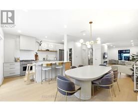 A modern kitchen with a dining table and chairs.