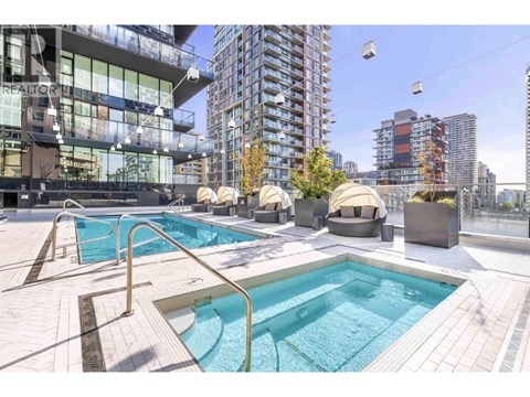 A swimming pool on a rooftop with a cityscape in the background.