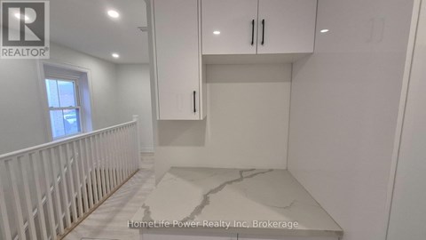 A white room with a marble floor and a window.