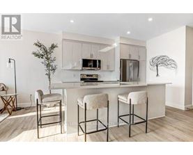 A modern kitchen with white cabinets and a central island.