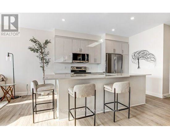 A modern kitchen with white cabinets and a central island.