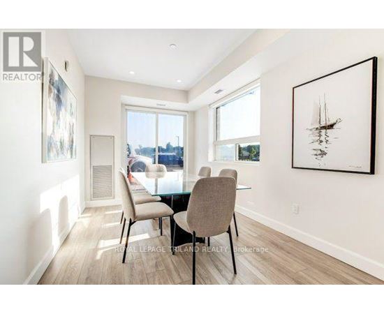 A dining room with a table and chairs.