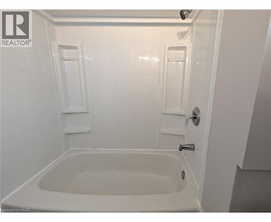A white bathroom with a tub and shower.