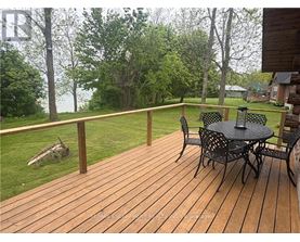 A wooden deck with a table and chairs.
