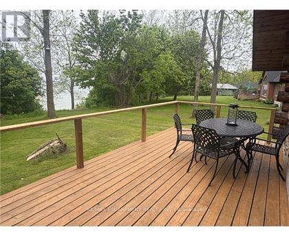 A wooden deck with a table and chairs.