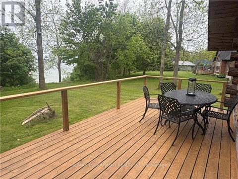 A wooden deck with a table and chairs.