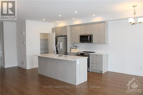 A modern kitchen with a large island in the middle.