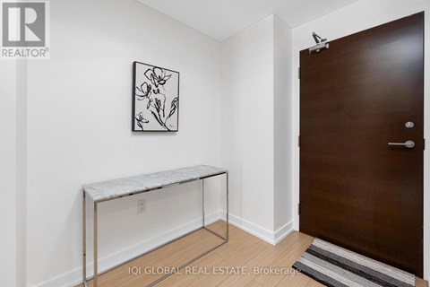 A room with a white wall and a picture of a deer on it.