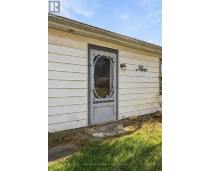 A white house with a door and a window.