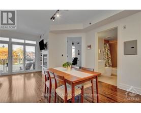 A dining room with a wooden table and chairs.