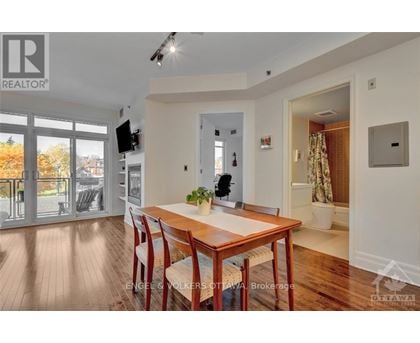 A dining room with a wooden table and chairs.