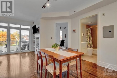 A dining room with a wooden table and chairs.