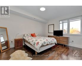 A bedroom with a bed, a dresser, and a mirror.