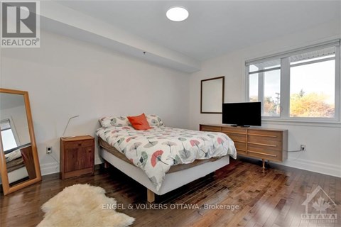 A bedroom with a bed, a dresser, and a mirror.
