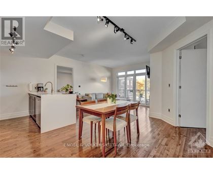 A modern kitchen with a dining table set for four.