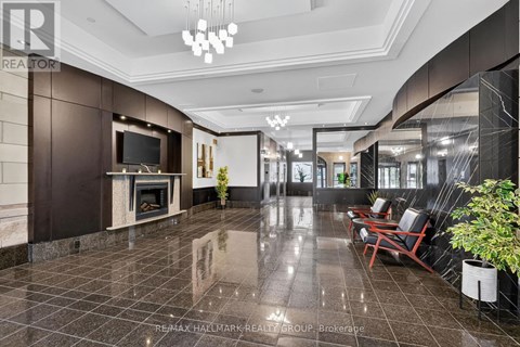 A spacious lobby with a fireplace and seating area.
