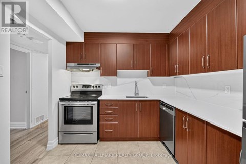 A kitchen with wooden cabinets and a white counter top.