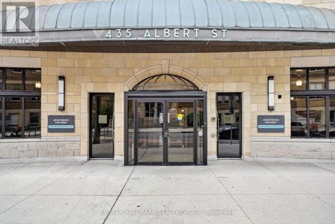 The front of a building with a glass door and a sign that says REALTOR.