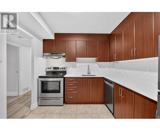 A kitchen with wooden cabinets and a white counter top.