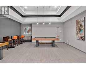 A room with a pool table and a billiard table.
