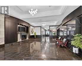 A spacious lobby with a fireplace and seating area.