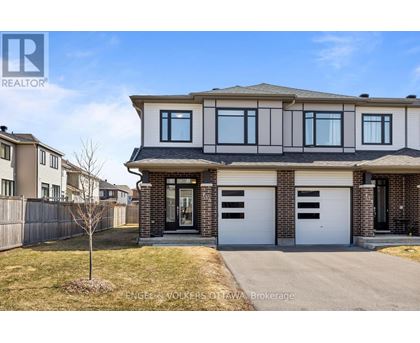 A house with a brown and white facade is for sale.