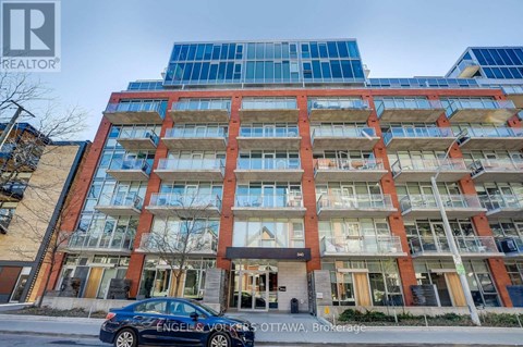 A car is parked in front of a building with the sign "Engels & Volkers OTTAWA Brokerage".