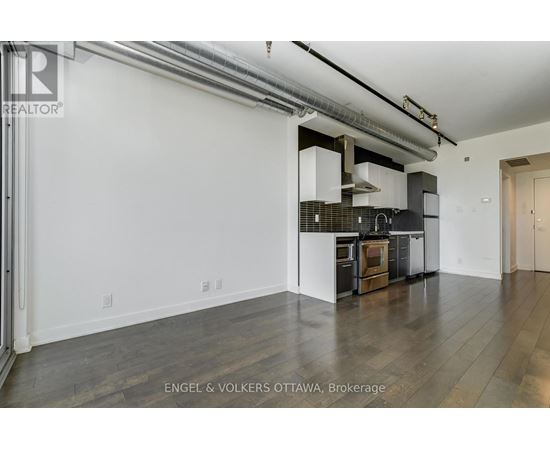 A modern kitchen with white cabinets and a black stove top oven.