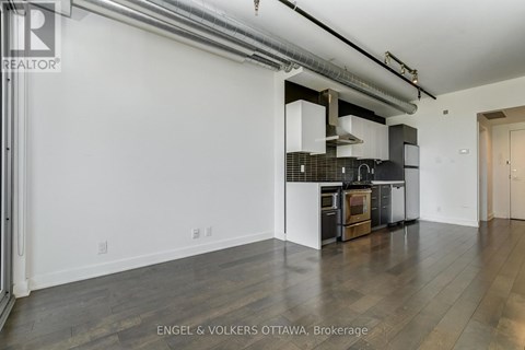 A modern kitchen with white cabinets and a black stove top oven.